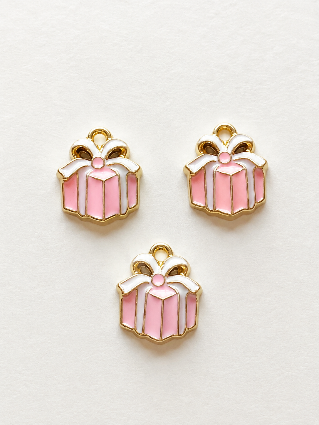 Pink enamel gift box with white bow earring and necklace set gold border