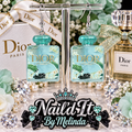 Dior Paris Teal Glitter Perfume Bottle Dangle Earrings on display stand with Dior branded backdrop