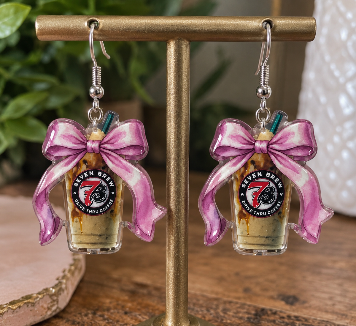 Seven Brew coffee dangle earrings with pink bow on display stand with Nail'd It By Melinda branding