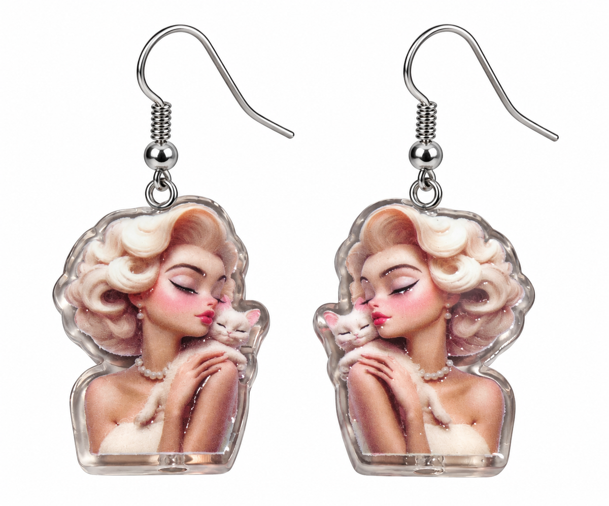 Glam girl and kitty dangle earrings – product close-up on white background
