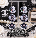 Chanel Inspired Fashion Doll Triple Dangle Earrings on display stand with Chanel backdrop