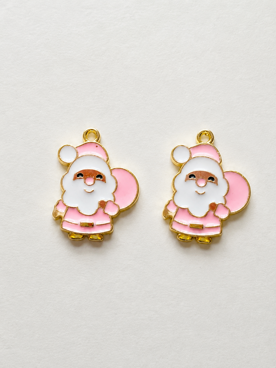 Pink enamel full body Santa Claus with gift bag earrings gold border