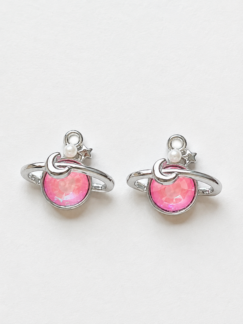 Pink crystal Saturn planet earrings with moon pearl and star accents