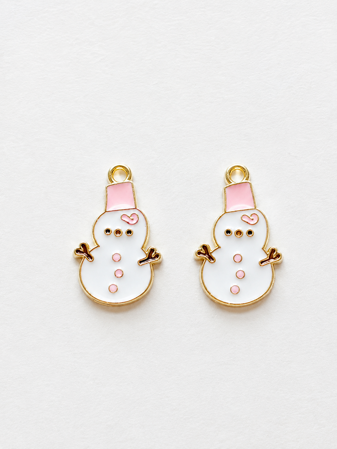 White and pink enamel snowman earrings with pink hat and gold border