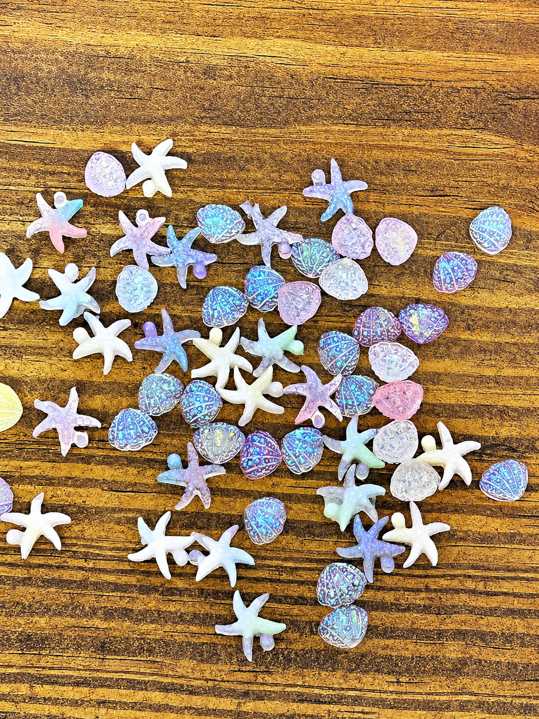 Happy Shores starfish and seashell nail charms in pastel iridescent colors