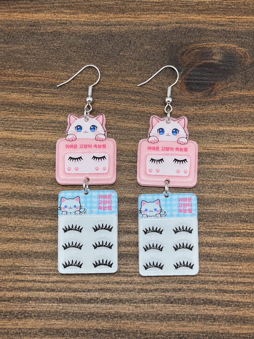 Kawaii Cat Lash Earrings - flat lay on wood surface