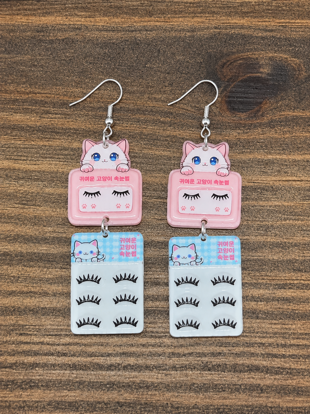 Kawaii Cat Lash Earrings - flat lay on wood surface