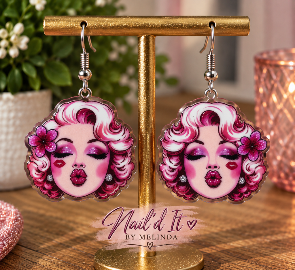 Pink glam icon kisses dangle earrings on gold display stand – Nail'd It By Melinda branded lifestyle shot