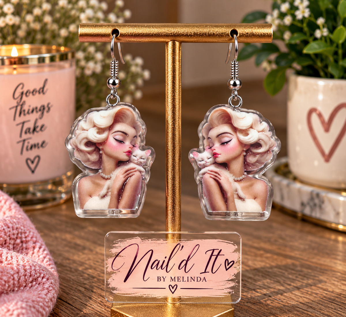 Glam girl and kitty dangle earrings on gold display stand – Nail'd It By Melinda branded lifestyle shot
